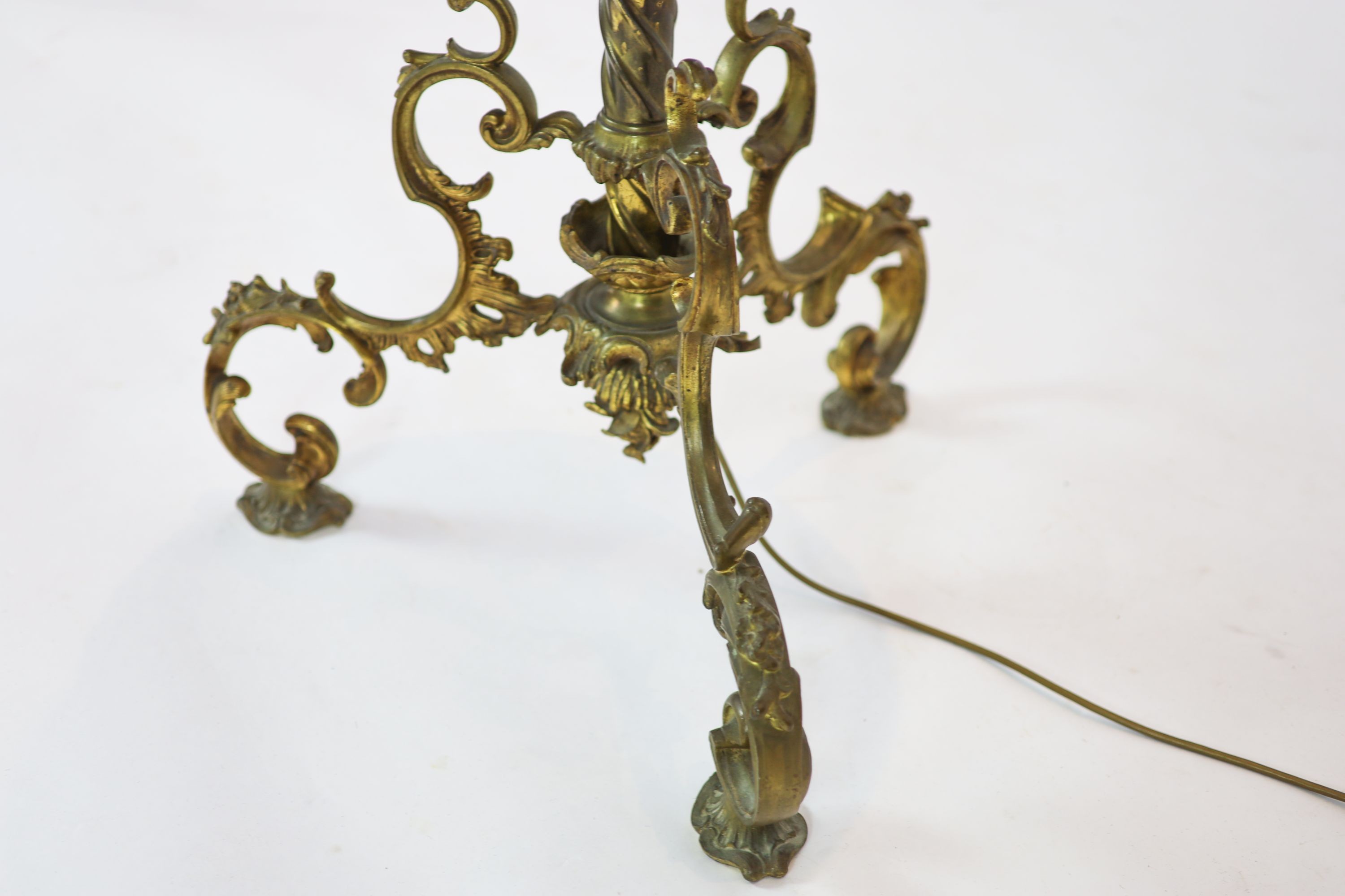 A late Victorian cast brass lamp standard, the column with an alabaster mid tier, raised on an open scrolled tripod base, converted to electricity, height 152cm